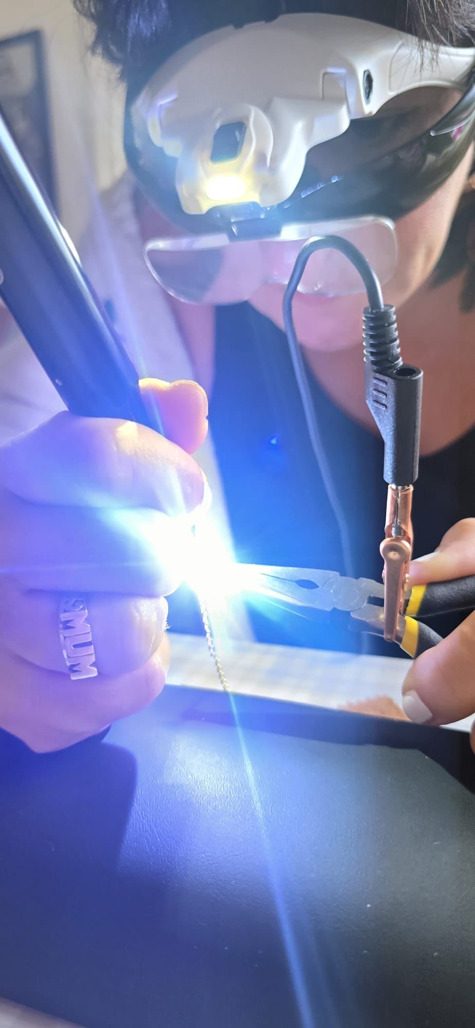 Sam professionally welding a permanent jewellery chain