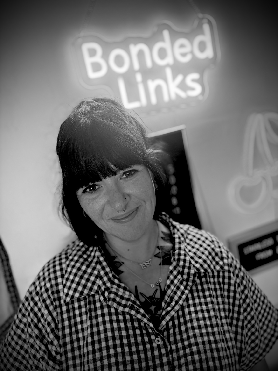 Sam at the studio with the Bonded Links sign behind her