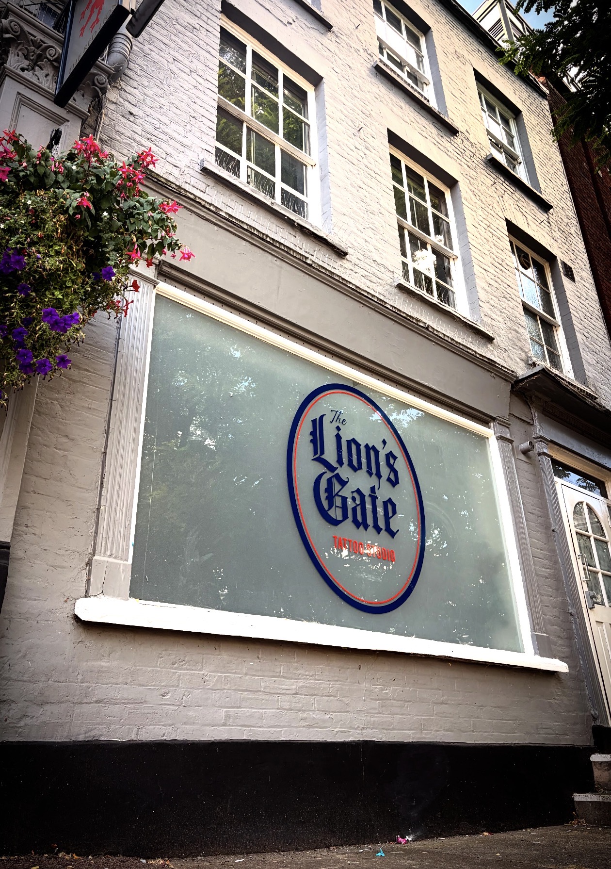 The Lion’s Gate exterior with its original navy and orange window logo