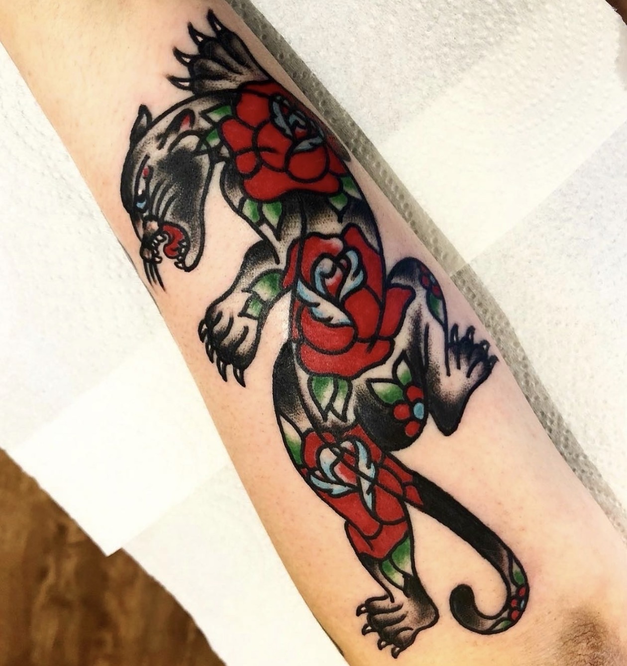 Traditional climbing panther with red roses