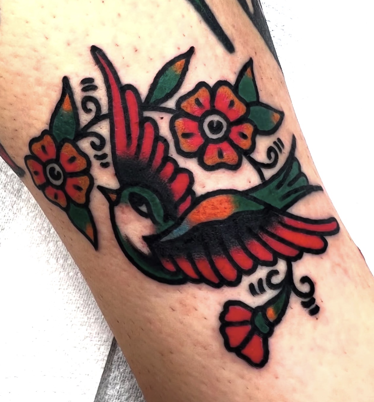 Traditional swallow and flowers in red, orange and green